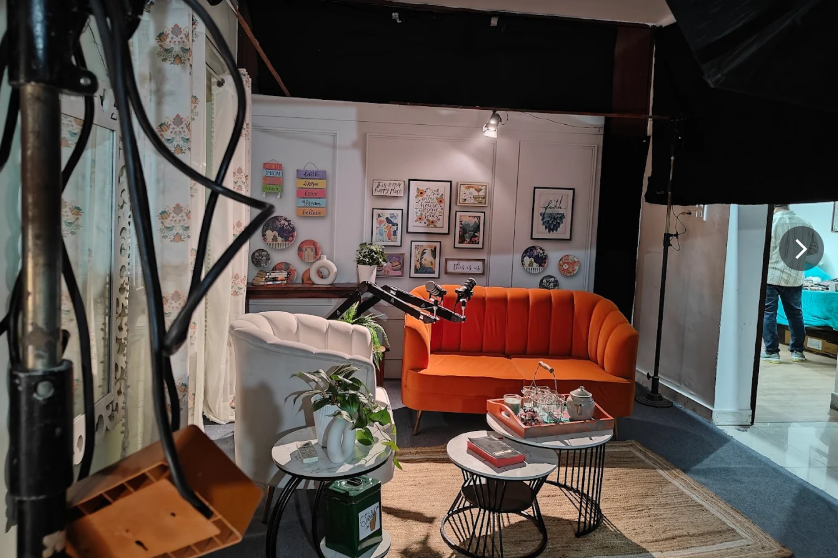 Podcast studio set with orange sofa